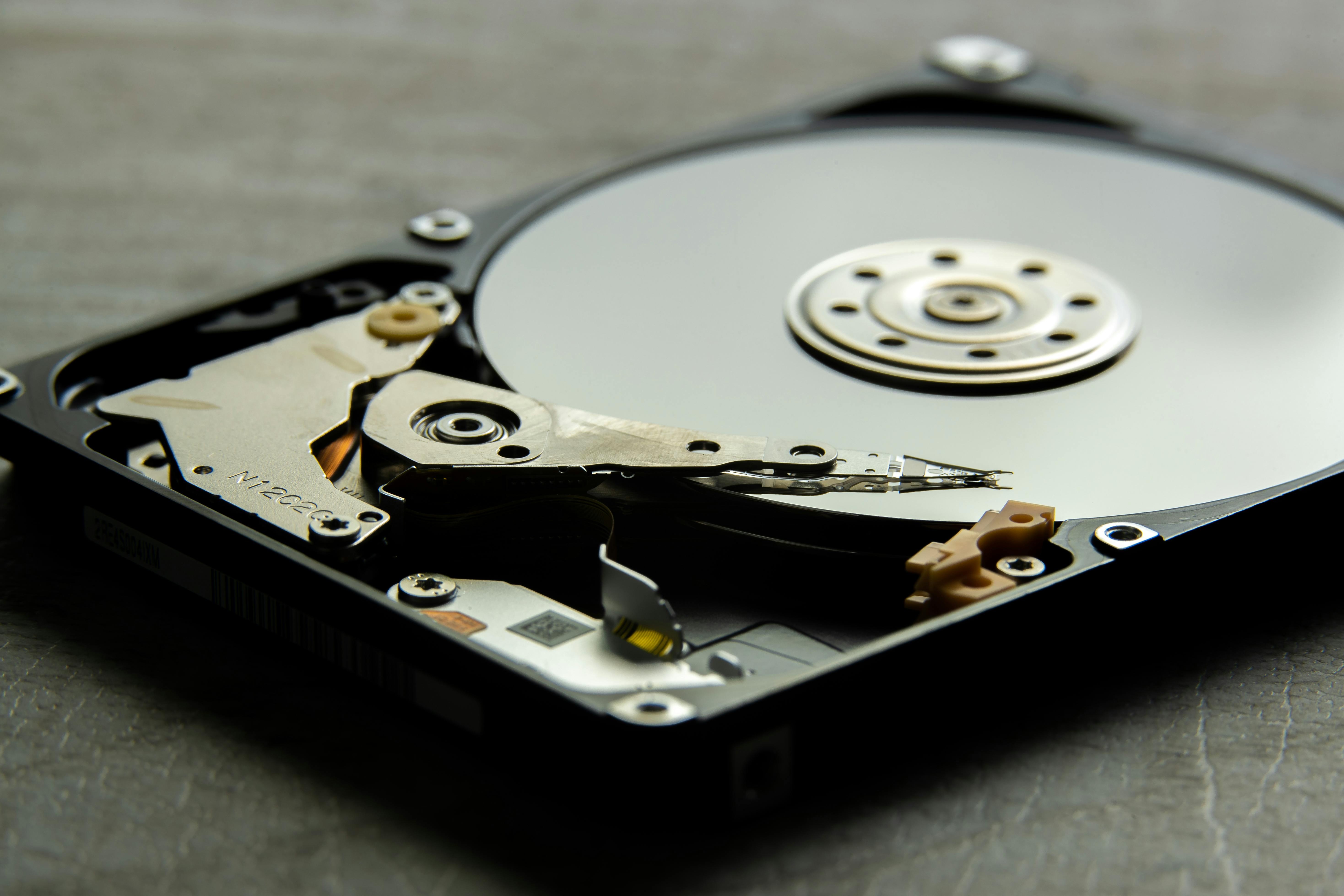 Photorealistic close-up of a hard drive platter representing backup and data protection
